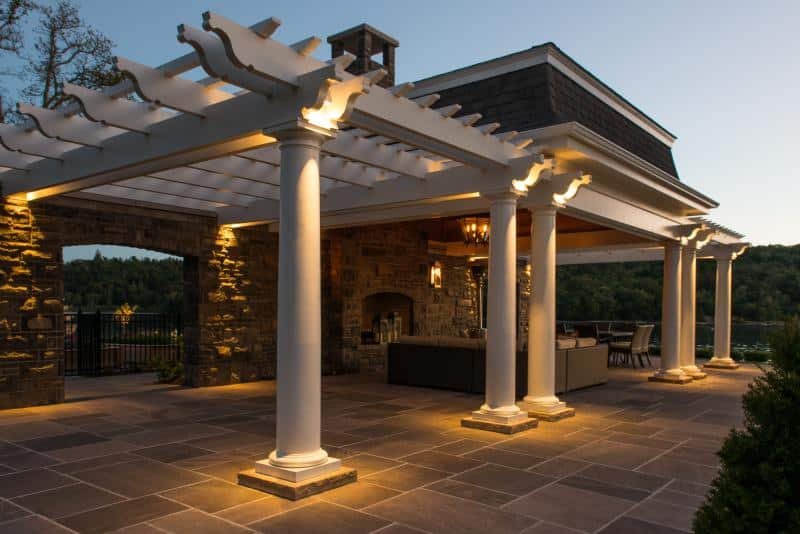 Outdoor patio lighting illuminating a covered pergola and entertaining area